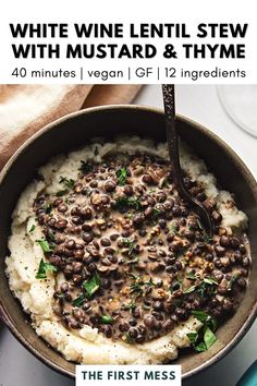 white wine lentil stew with mustard and thyme in a bowl on top of mashed potatoes