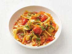 a white bowl filled with pasta and tomato sauce