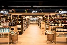 a store filled with lots of bottles and baskets full of wine next to each other