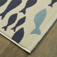 a rug with blue and white fish on it