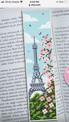 the cross stitch bookmark is decorated with an image of the eiffel tower