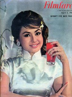 a woman holding a red drink in her hand