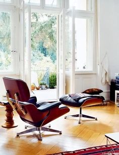 an eames chair and ottoman in a living room