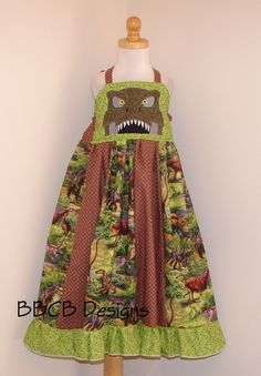 Girls T-Rex Dinosaur Dress Ready to Ship This will fit approx. 6/7 depends on your dress length pref. Dress length - top of bodice to hem >> is approx: 27 inches Waist/chest stretches to max of 26 inches HOW TO MEASURE: To compare the length of the dress to your child start at her chest- level with her armpit and measure down from there the length of the dress. The bodice is lined on the inside and in back of the dress is an encased elastic band for a comfy fit. The straps go through the loop so Jungle Outfit, Dino Dress, Chest Stretches, Dinosaur Dress, Safari Dress, Girl Dinosaur, Birthday Party Outfits, Theme Dress, T Rex Dinosaur