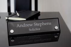 there is a black and white sign on the table that says andrew stephens solution