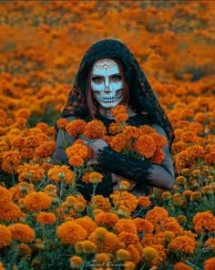 a woman with skeleton makeup holding flowers in her hands and looking at the camera while standing in a field full of orange flowers