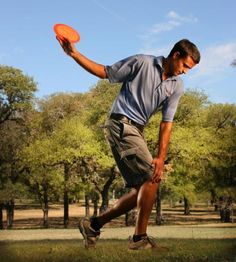 a man is playing frisbee in the park