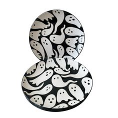 two black and white plates with ghost faces on them, one is shaped like an eight