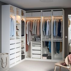 a white closet filled with lots of clothes