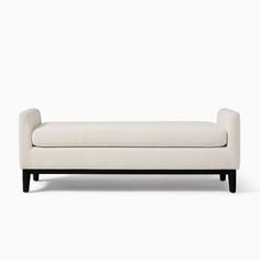 a white couch sitting on top of a wooden frame