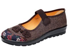 a women's shoe with flowers on the side and black outstep,