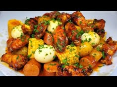 a white plate topped with chicken, potatoes and carrots