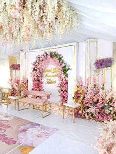 a room filled with lots of pink and white flowers