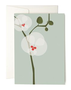 a greeting card with white flowers and green leaves on the front, against a gray background