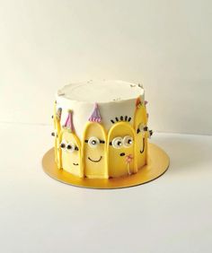 a yellow cake with three faces on it