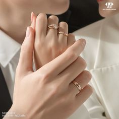 the woman is wearing two different rings on her finger and one has an engagement ring