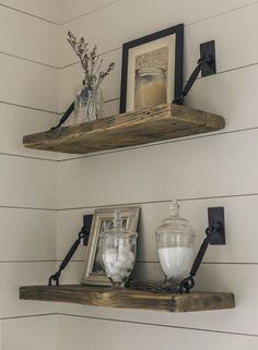 two wooden shelves with framed pictures on them