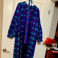 African Taylor Made Ankara Dress Coat Blue And Purple Circle Design Blue Maxi Dress For Daywear, Blue Long Sleeve Midi Dress For Daywear, Bohemian Long Sleeve Royal Blue Dress, Bohemian Royal Blue Long Sleeve Dress, Royal Blue Long Sleeve Bohemian Dress, Bohemian Blue Midi Dress For Daywear, Elegant Blue Tunic Maxi Dress, Blue Spring Midi Dress, Casual Long Blue Midi Dress