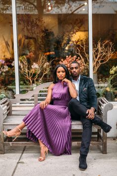 a man and woman are sitting on a bench