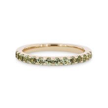 a yellow gold band with green diamonds