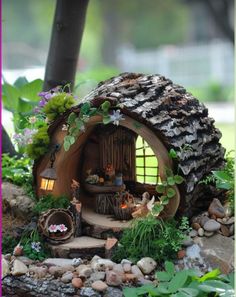 a fairy garden with a tree stump house