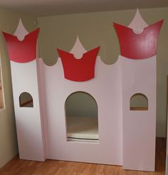 a child's bedroom with a pink castle bed