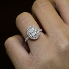 a woman's hand with a diamond ring on it