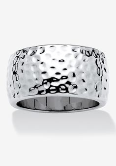 a white gold ring with black dots on the outside and an intricate design in the middle