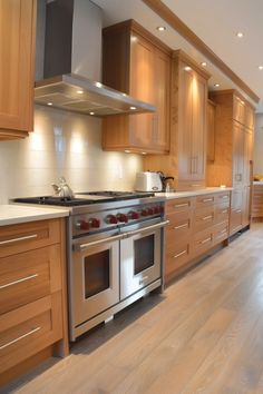 a kitchen with wooden cabinets and stainless steel appliances