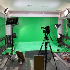 a green screen studio with several lights and equipment in front of the camera set up