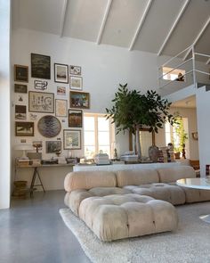 a living room filled with furniture and pictures on the wall