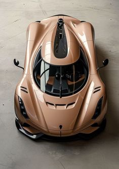 an overhead view of a sports car in the middle of a concrete floored area