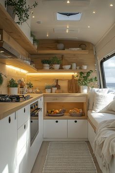 the interior of a camper with white cupboards and wood shelves on both sides