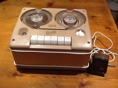 an old radio sitting on top of a wooden table