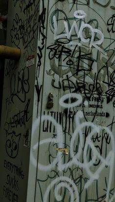 the door is covered in graffiti and has writing on it