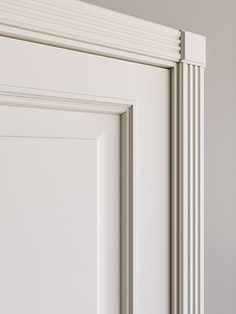 an open door with white trim on the front and side panels, in a room