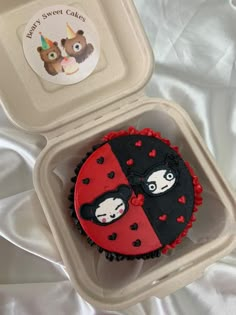 a cupcake in a plastic container with a lady bug design on the front and side