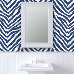 a white sink sitting under a bathroom mirror next to a wall mounted faucet