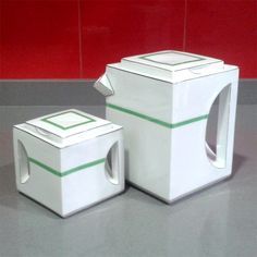 two white boxes sitting next to each other on a table