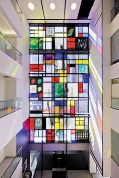 the interior of an office building with multiple colored glass blocks on the wall and floor