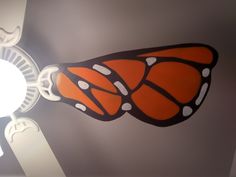 an orange and black butterfly painted on the ceiling