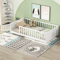 a baby's room with green walls and white furniture