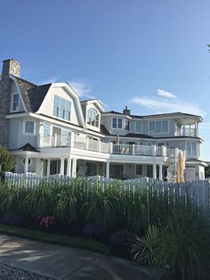 a large white house sitting on the side of a road