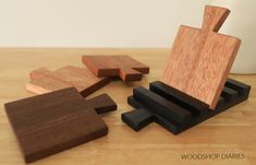 three pieces of wood sitting on top of a wooden table next to each other,