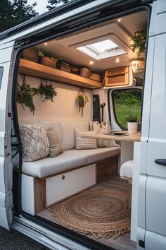 the interior of a camper van with its door open to reveal a couch and storage area