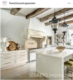 a large kitchen with white cabinets and an island in front of a stove top oven