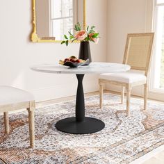 a white table with flowers and fruit on it