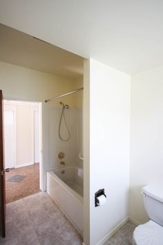 the bathroom is clean and ready to be used as a bathtub, shower or toilet