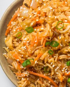 a brown plate filled with rice and vegetables