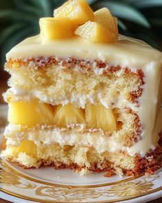 a piece of cake on a plate with pineapples and icing around it